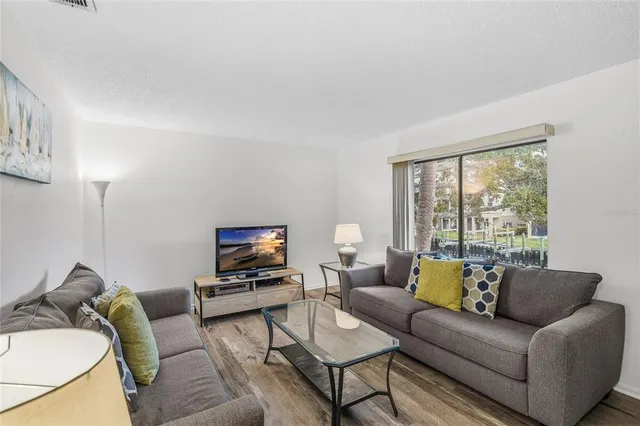 a spacious bedroom with a bed and a dresser