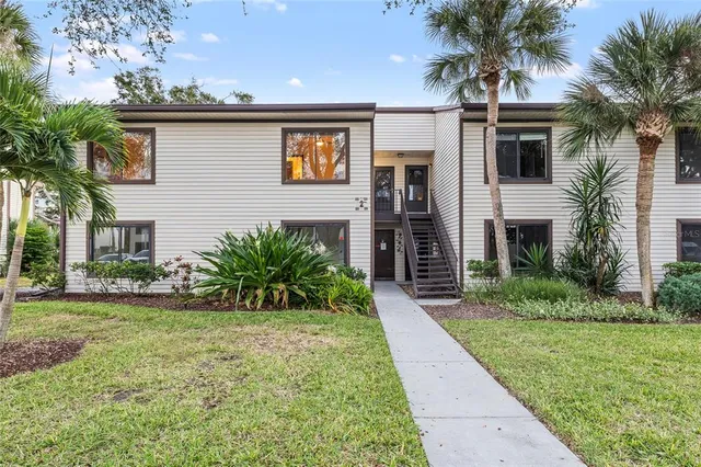 a kitchen with stainless steel appliances granite countertop a sink a stove a microwave and refrigerator