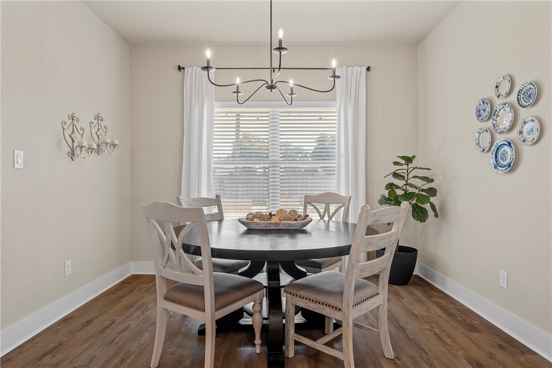 848 Gallant Fox Hewitt, TX 76643 - Photo 11 of 32 a view of a dining room with furniture window and wooden floor
