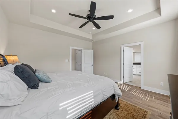 a bedroom with a bed and a chandelier