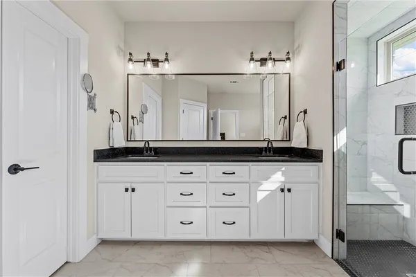 a bathroom with a sink vanity and mirror