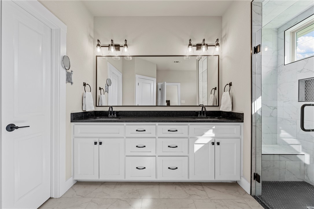 848 Gallant Fox Hewitt, TX 76643 - Photo 19 of 32 a bathroom with a sink vanity and mirror