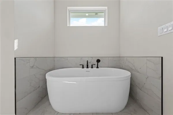 a white bath tub sitting in a bathroom