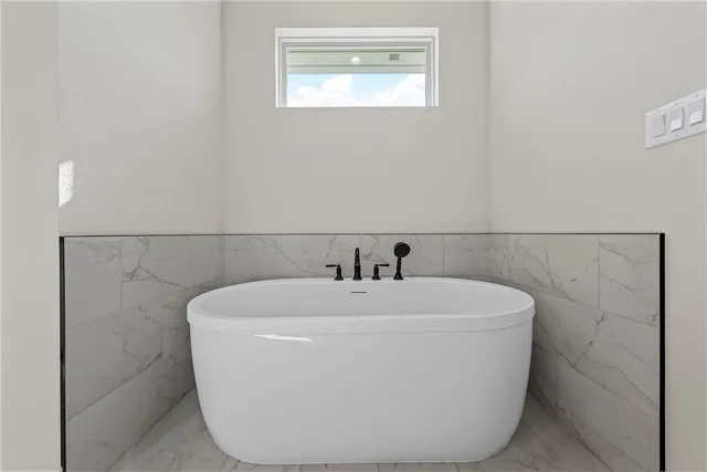 a white bath tub sitting in a bathroom