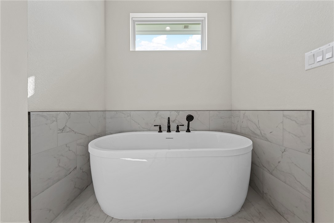 848 Gallant Fox Hewitt, TX 76643 - Photo 20 of 32 a white bath tub sitting in a bathroom