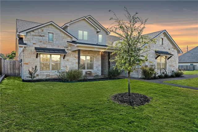 a front view of a house with a yard