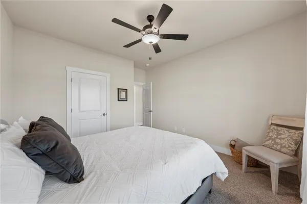 a bedroom with a bed and a chair