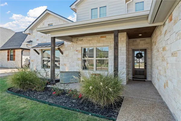 a front view of a house with a garden