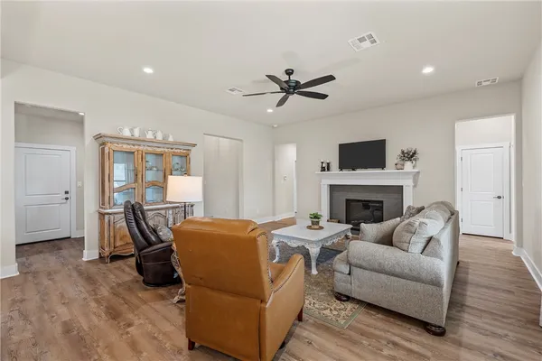 a living room with furniture a fireplace and a flat screen tv