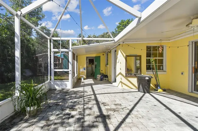 a view of a porch with furniture and backyard