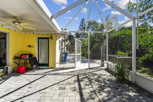 a view of a patio with a table and chairs