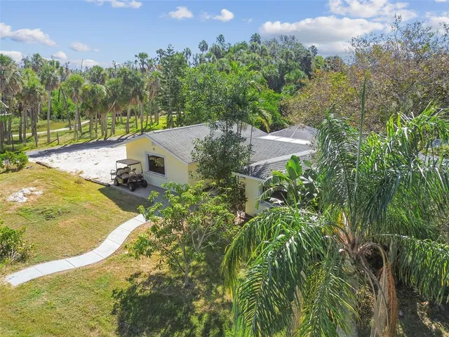 an aerial view of a house with a garden and trees