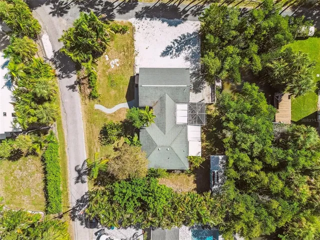 an aerial view of a house with a yard and garden
