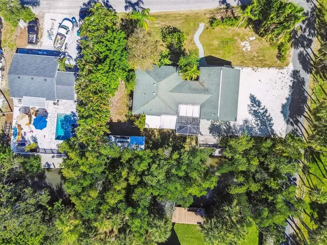 an aerial view of a house with a yard and garden