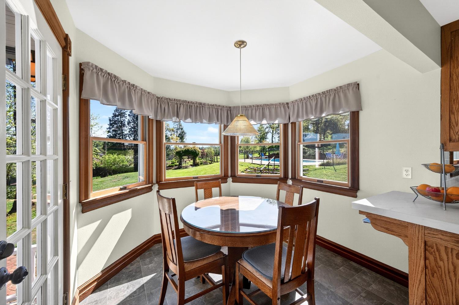 10800 Pickle Barrel Road Auburn, CA 95602 - Photo 21 of 82 a view of a dining room with furniture large windows and wooden floor