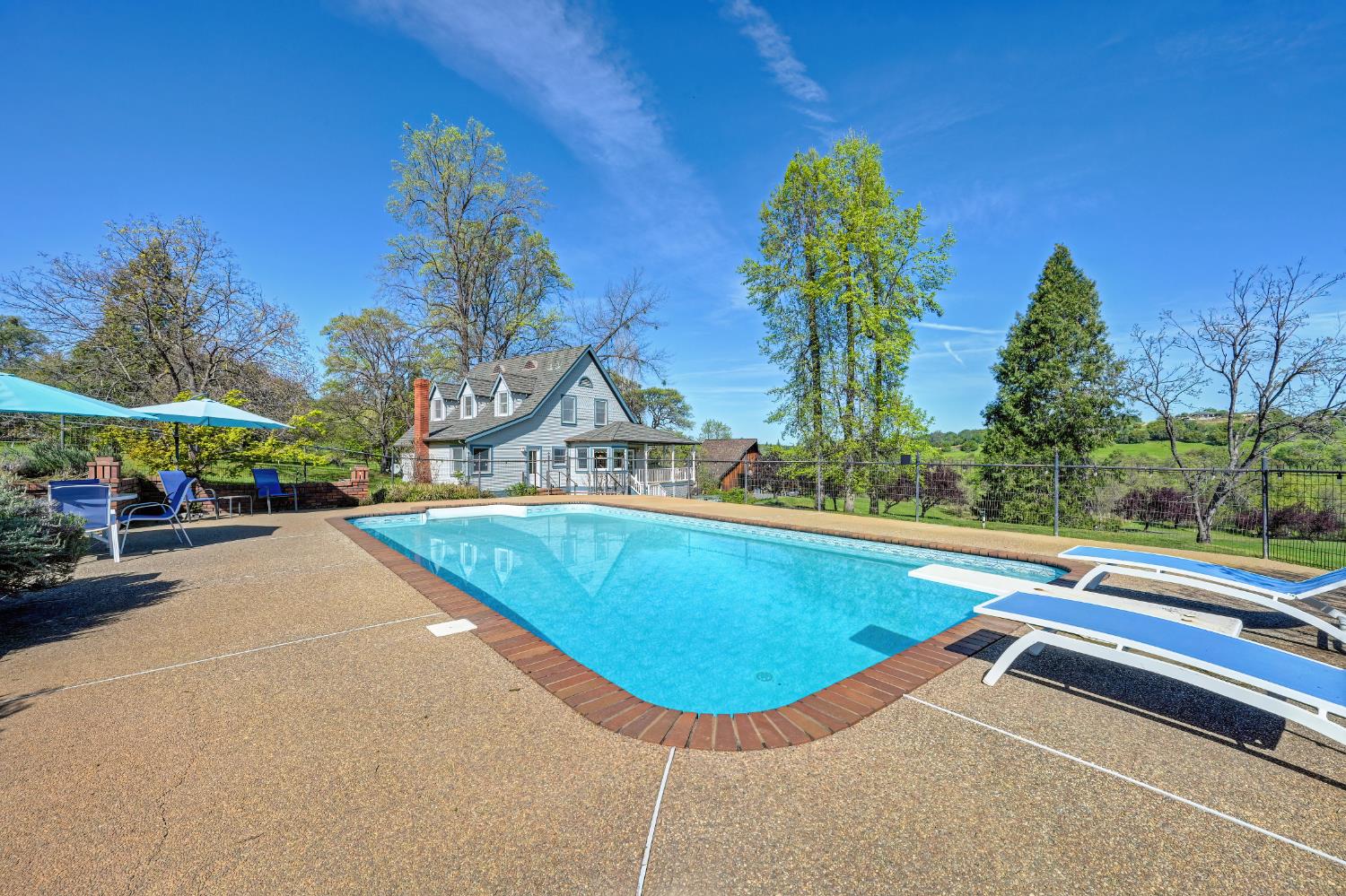 10800 Pickle Barrel Road Auburn, CA 95602 - Photo 38 of 82 a view of a swimming pool with a bench in front of house