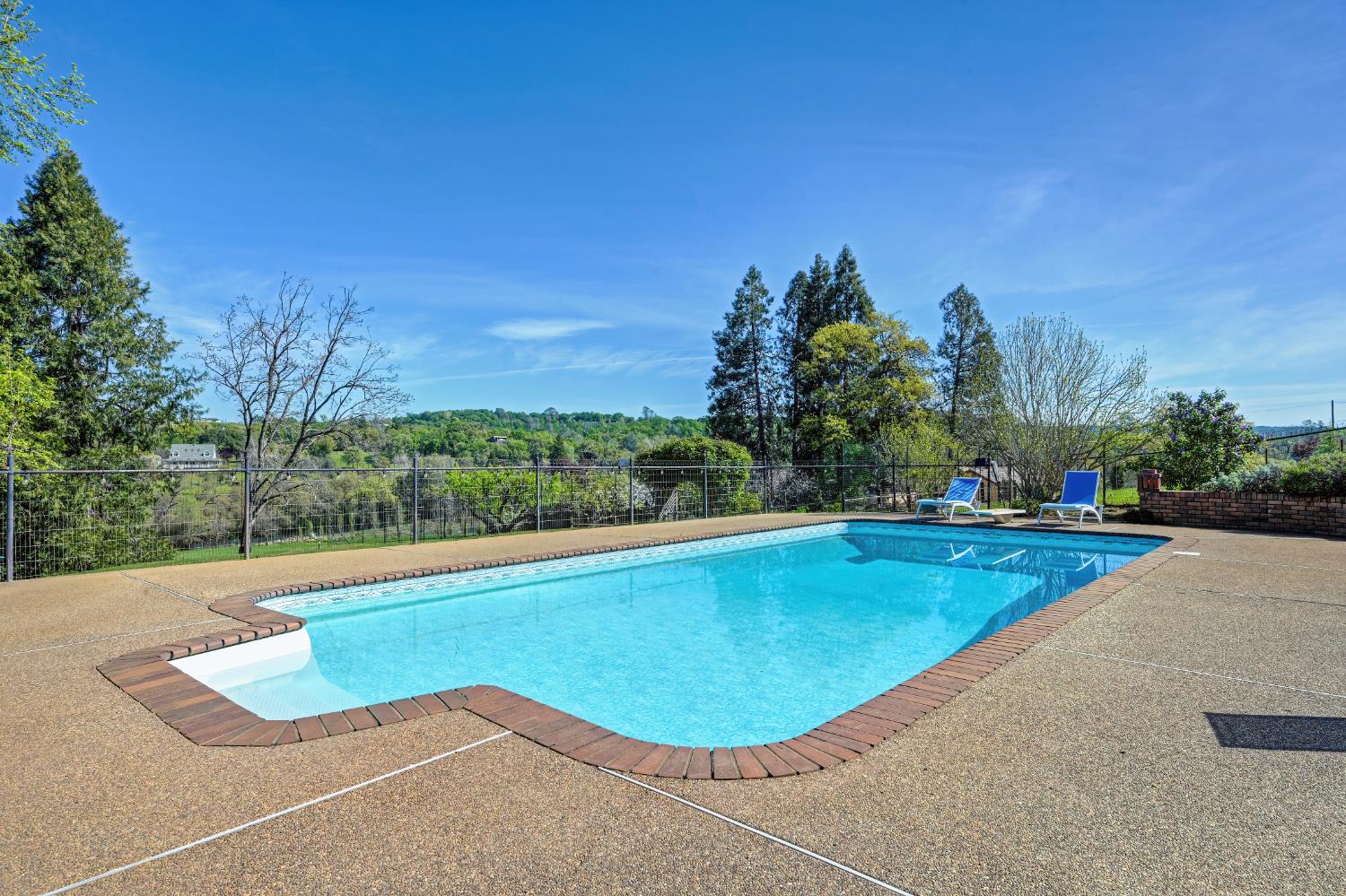 10800 Pickle Barrel Road Auburn, CA 95602 - Photo 40 of 82 a view of a swimming pool and trees in the background