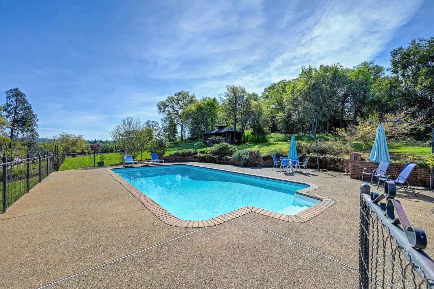 10800 Pickle Barrel Road Auburn, CA 95602 - Photo 41 of 82 a view of a swimming pool with a patio and a yard