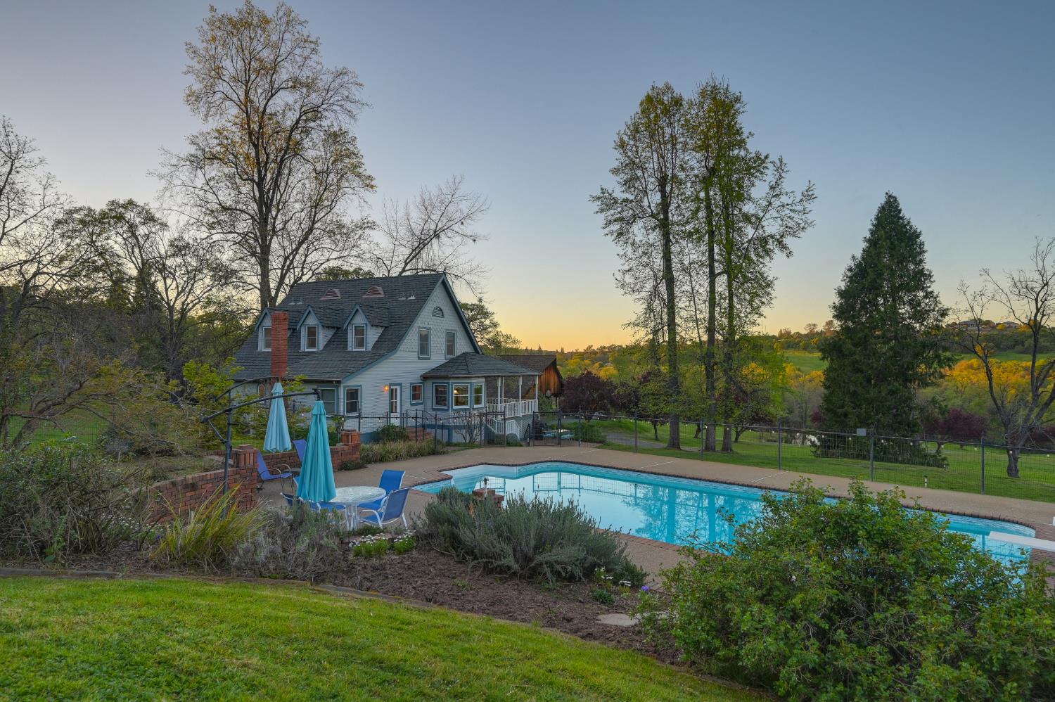 10800 Pickle Barrel Road Auburn, CA 95602 - Photo 65 of 82 a view of a house with a big yard and potted plants and large trees