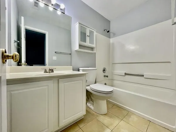 a bathroom with a toilet sink and a mirror