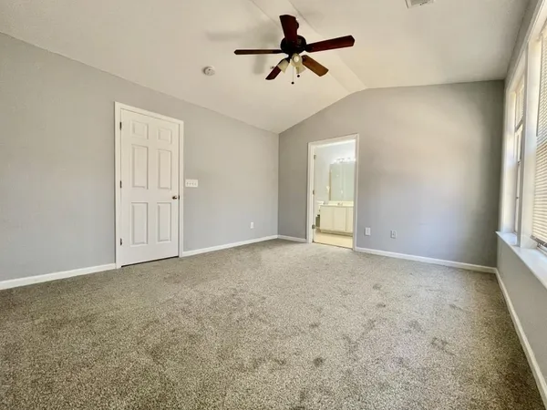 a view of a livingroom with a ceiling fan and window