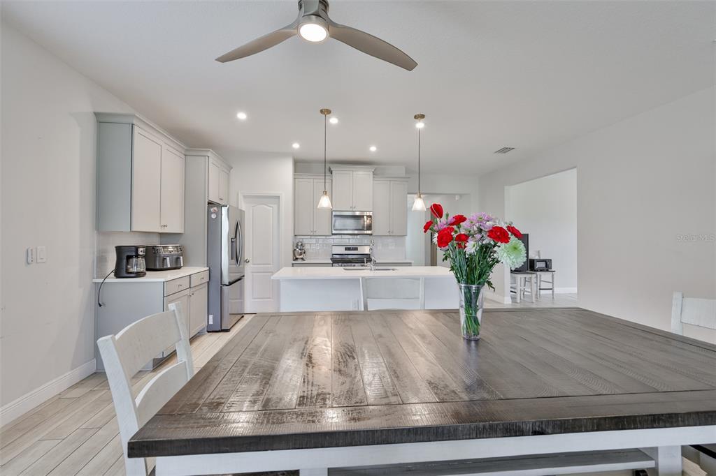 5418 Silver Sun Drive Apollo Beach, FL 33572 - Photo 12 of 65 a room with kitchen island granite countertop stainless steel appliances sink microwave and stove