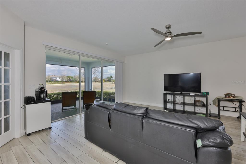 5418 Silver Sun Drive Apollo Beach, FL 33572 - Photo 15 of 65 a living room with furniture and a flat screen tv