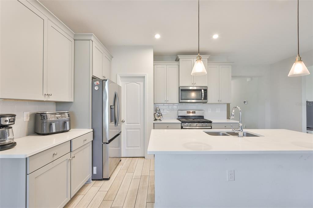 5418 Silver Sun Drive Apollo Beach, FL 33572 - Photo 17 of 65 a kitchen with stainless steel appliances a refrigerator sink and microwave