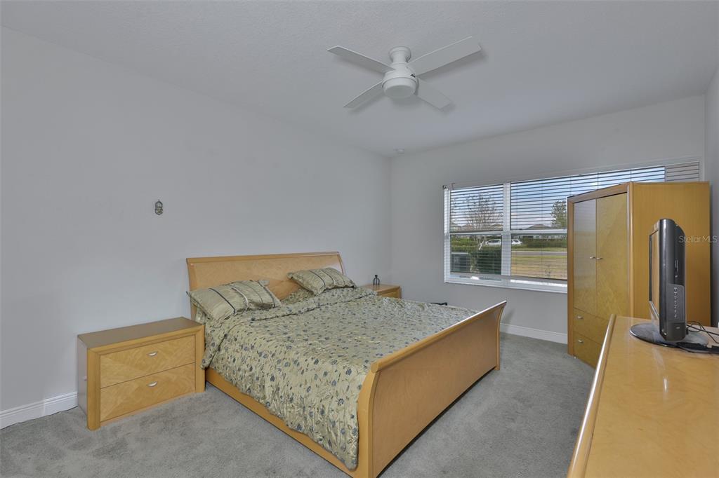 5418 Silver Sun Drive Apollo Beach, FL 33572 - Photo 18 of 65 a living room with a bed furniture and a flat screen tv