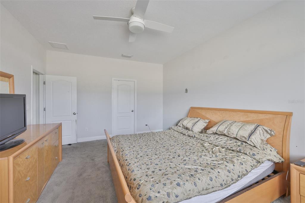 5418 Silver Sun Drive Apollo Beach, FL 33572 - Photo 19 of 65 a bedroom with a bed and flat screen tv
