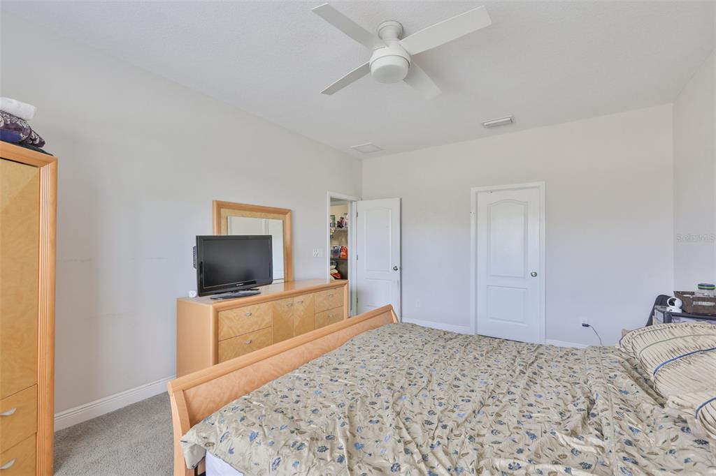5418 Silver Sun Drive Apollo Beach, FL 33572 - Photo 20 of 65 a bedroom with a bed and a flat screen tv
