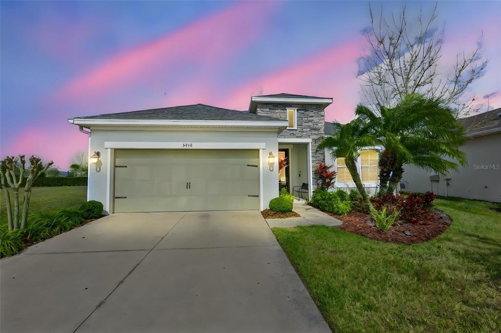 5418 Silver Sun Drive Apollo Beach, FL 33572 - Photo 2 of 65 a front view of a house with a yard and garage