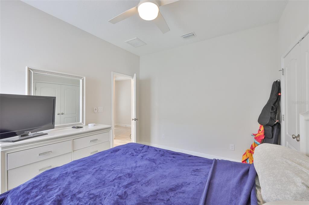 5418 Silver Sun Drive Apollo Beach, FL 33572 - Photo 32 of 65 a bedroom with a bed and a flat screen tv