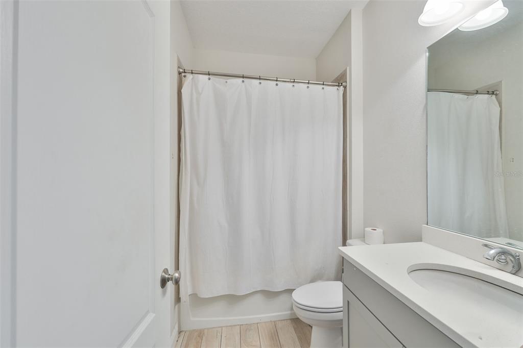 5418 Silver Sun Drive Apollo Beach, FL 33572 - Photo 33 of 65 a bathroom with a sink a toilet and shower curtain