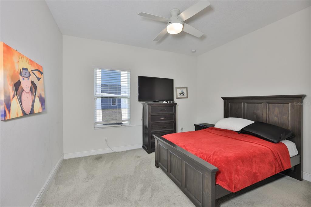 5418 Silver Sun Drive Apollo Beach, FL 33572 - Photo 34 of 65 a bedroom with a bed and a flat screen tv