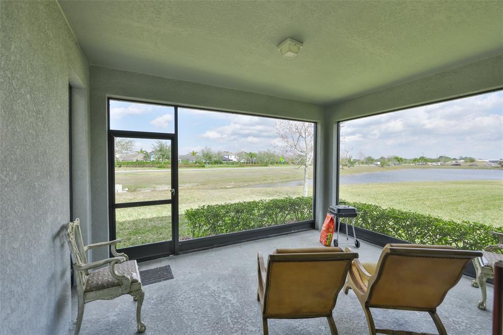 5418 Silver Sun Drive Apollo Beach, FL 33572 - Photo 37 of 65 a living room with a floor to ceiling window next to a yard