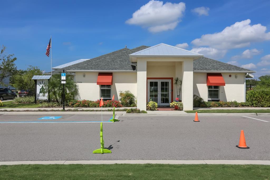 5418 Silver Sun Drive Apollo Beach, FL 33572 - Photo 46 of 65 a view of a white house with a swimming pool and a yard