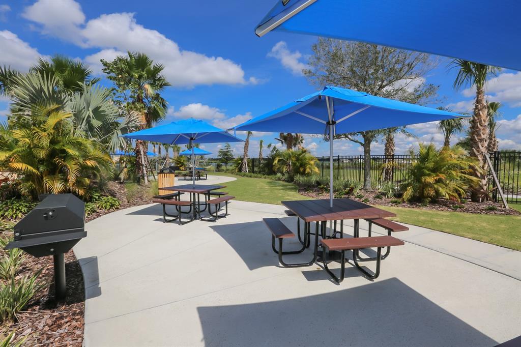 5418 Silver Sun Drive Apollo Beach, FL 33572 - Photo 49 of 65 a view of a patio with a table and chairs under an umbrella