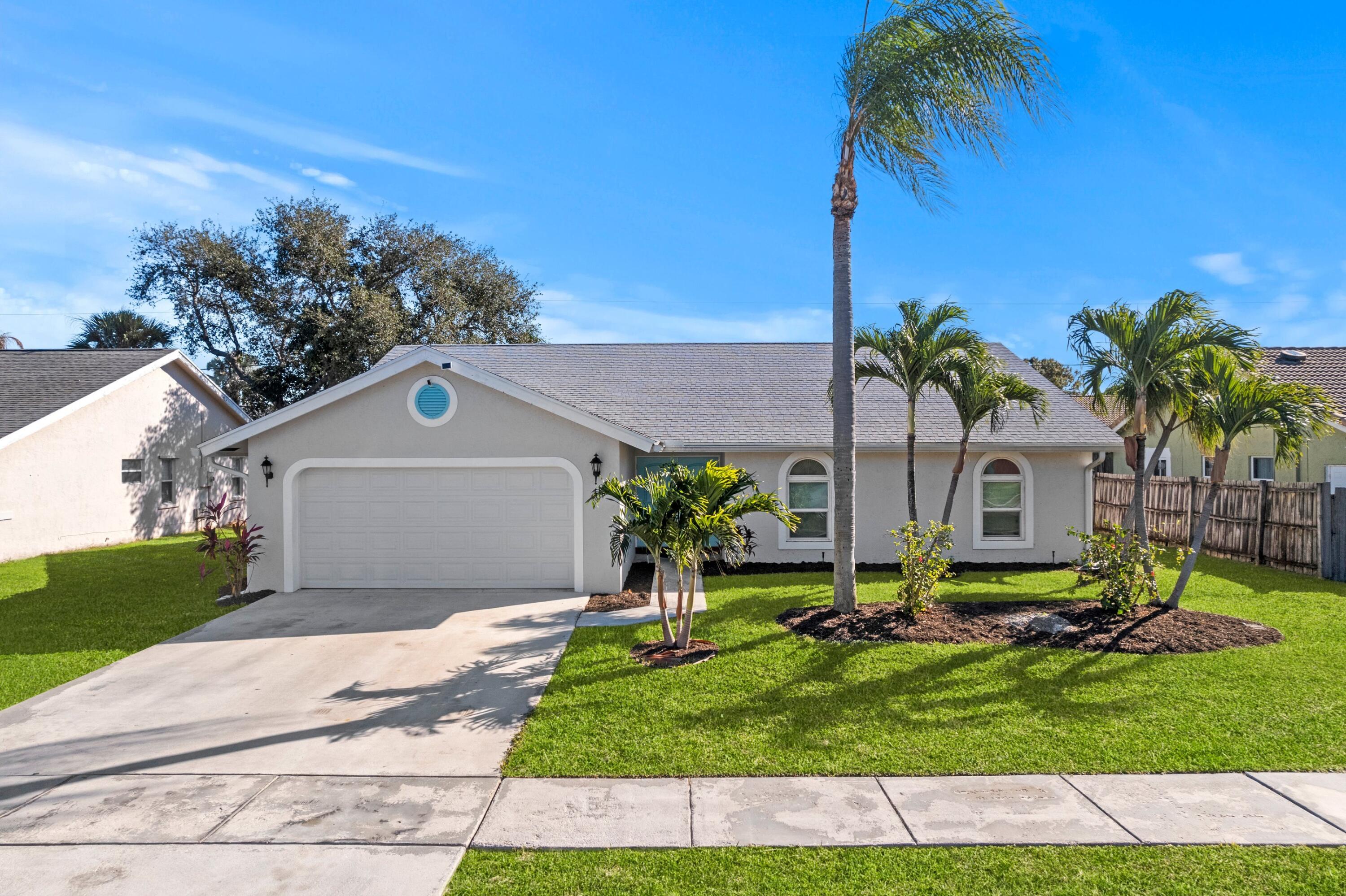 7944 Texas Trail Boca Raton, FL 33487 - Photo 1 of 27 a front view of house with yard and green space