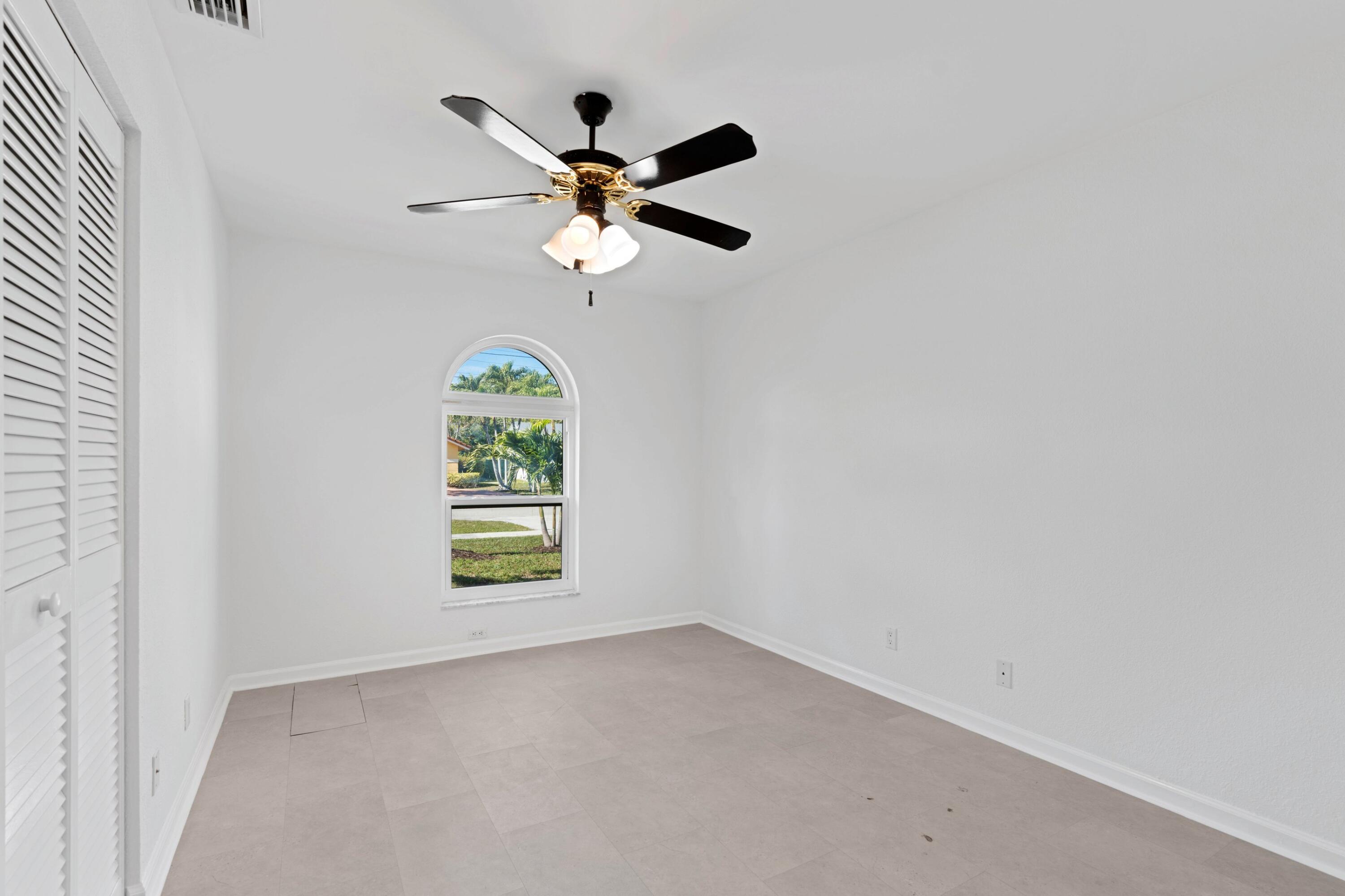 7944 Texas Trail Boca Raton, FL 33487 - Photo 11 of 27 an empty room with windows and fan