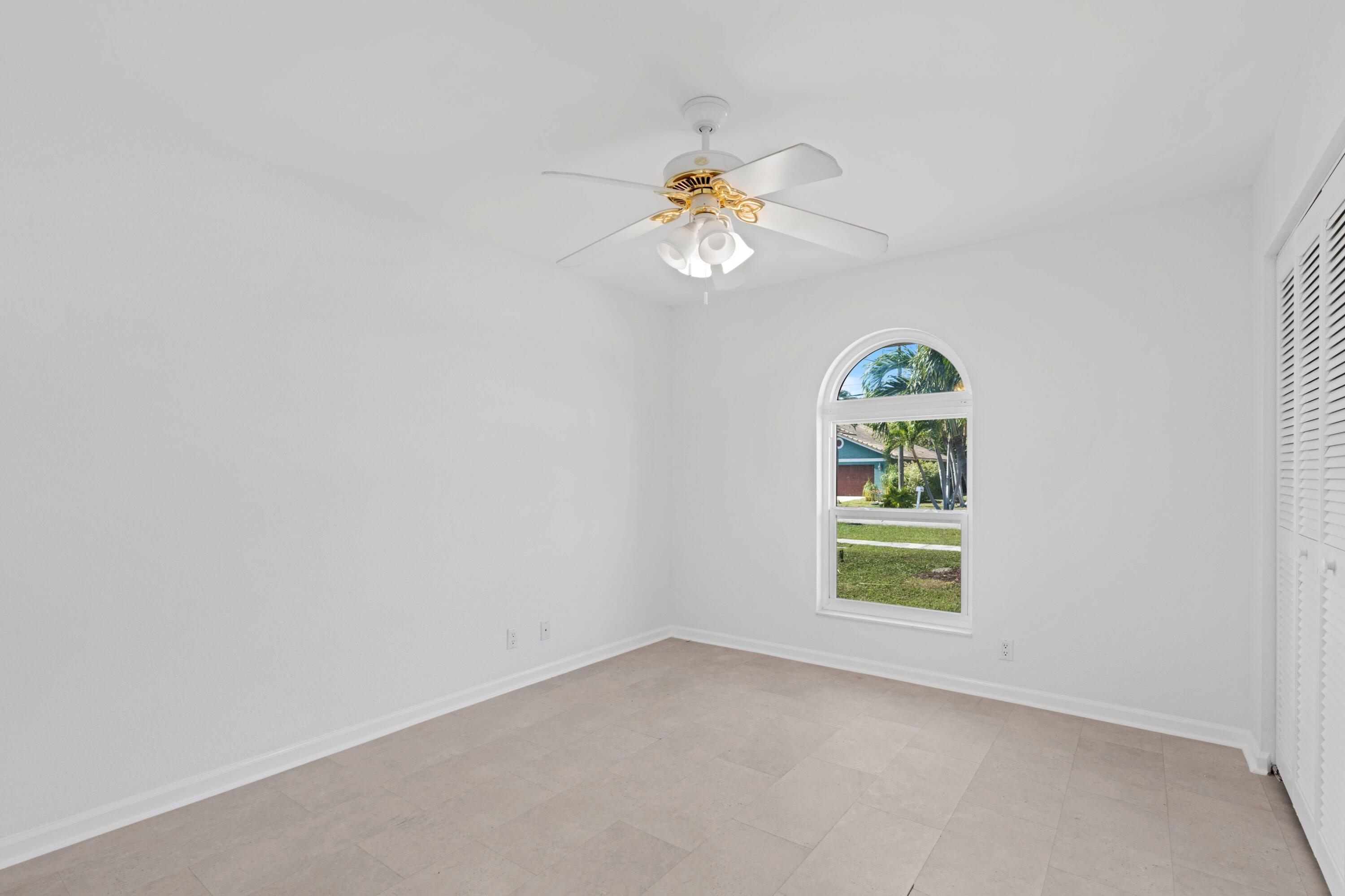 7944 Texas Trail Boca Raton, FL 33487 - Photo 13 of 27 an empty room with windows and fan