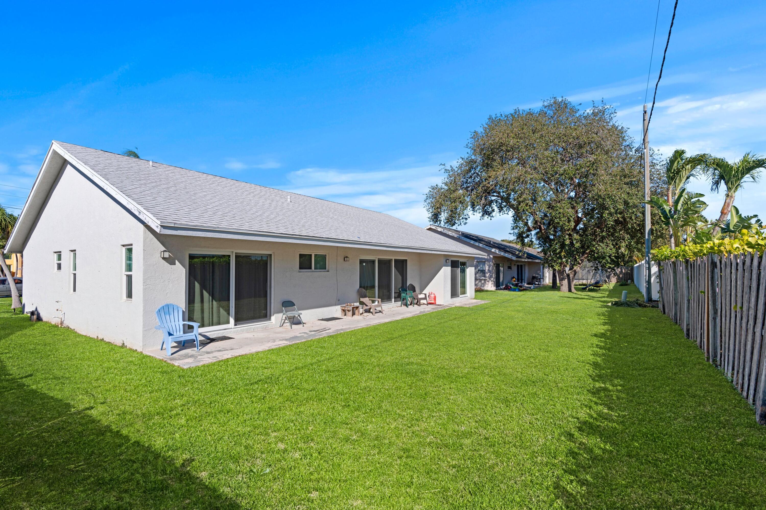7944 Texas Trail Boca Raton, FL 33487 - Photo 2 of 27 a view of a house with backyard porch and garden