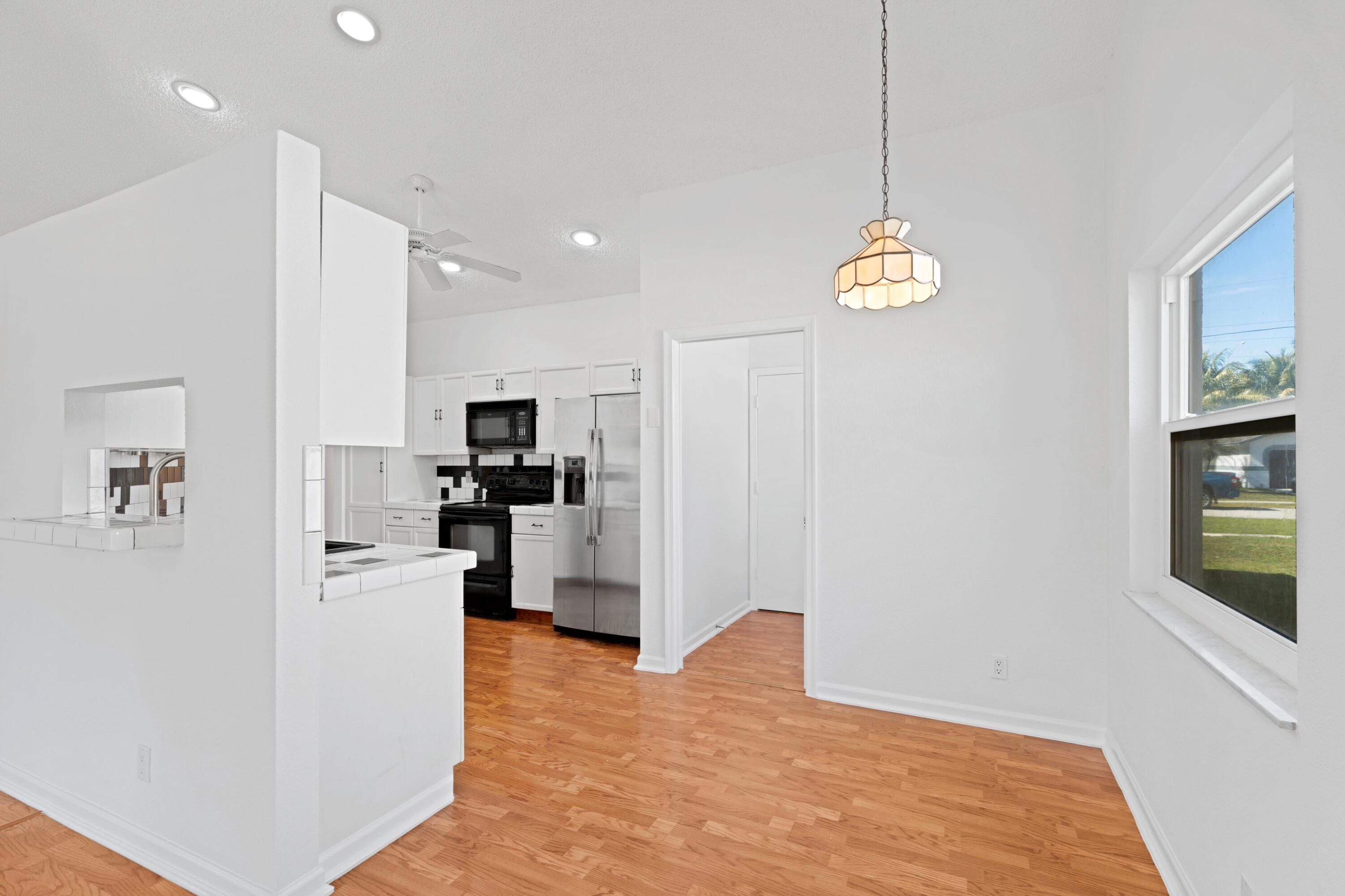 7944 Texas Trail Boca Raton, FL 33487 - Photo 6 of 27 a view of a kitchen with furniture and stainless steel appliances