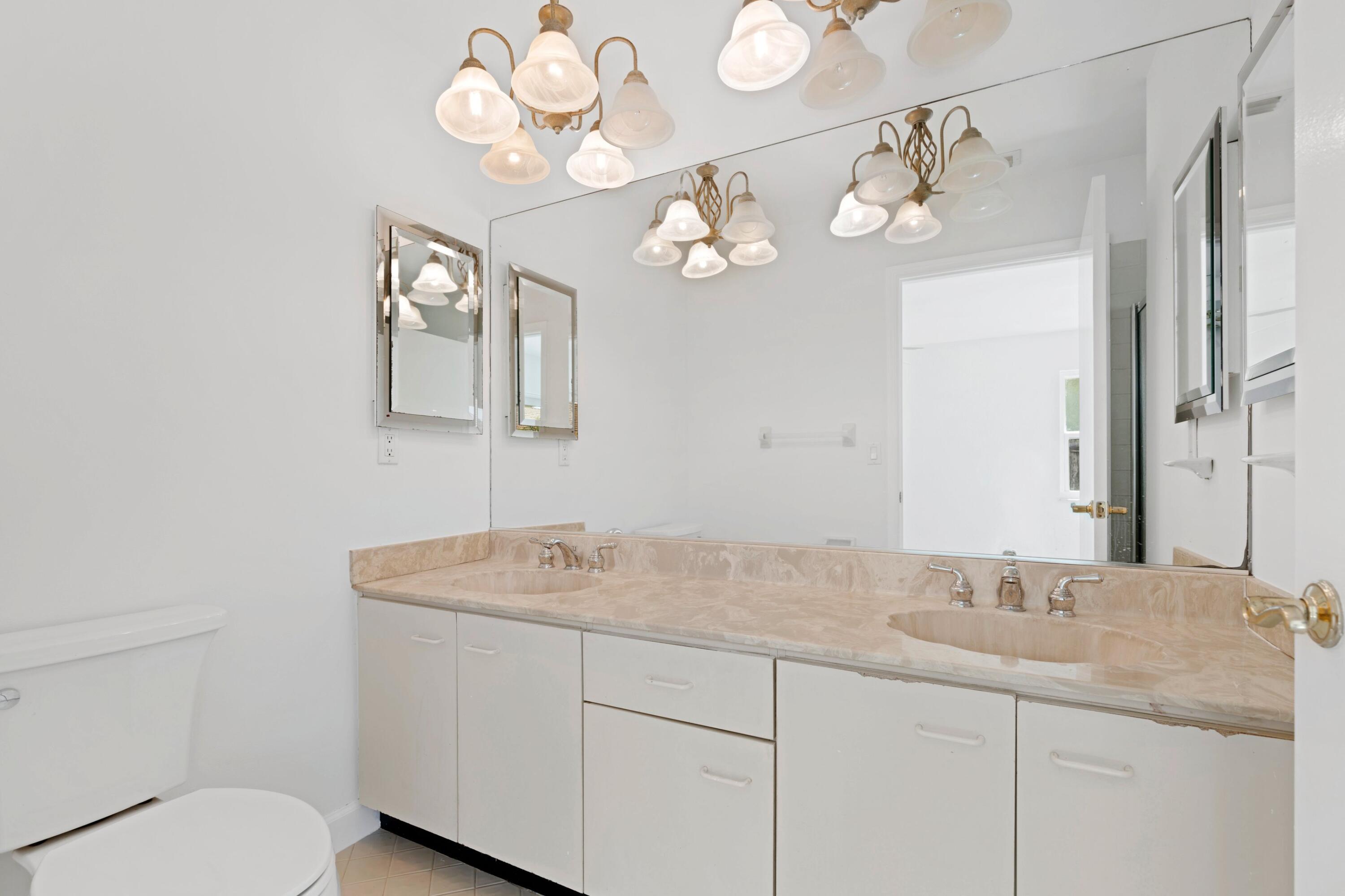 7944 Texas Trail Boca Raton, FL 33487 - Photo 10 of 27 a bathroom with a granite countertop sink and a mirror