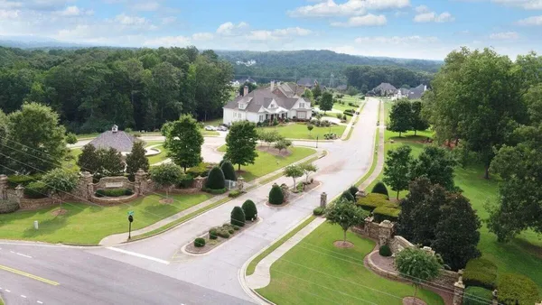 an aerial view of a house with a garden and swimming pool