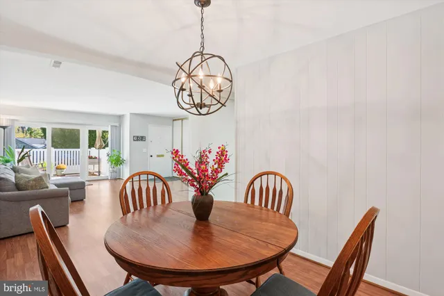 a dining room with furniture window and wooden floor