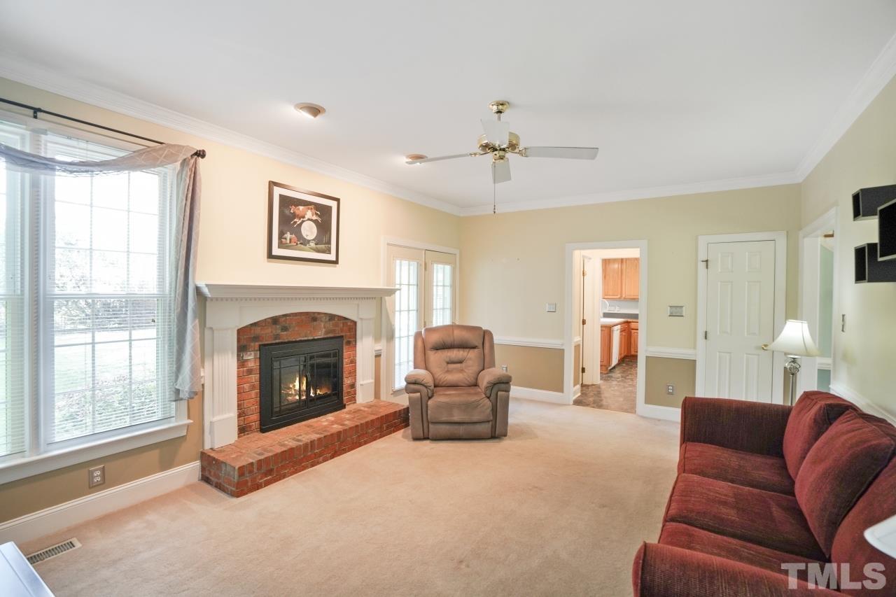 1505 Habbot Drive Raleigh, NC 27603 - Photo 12 of 32 a living room with furniture and a fireplace