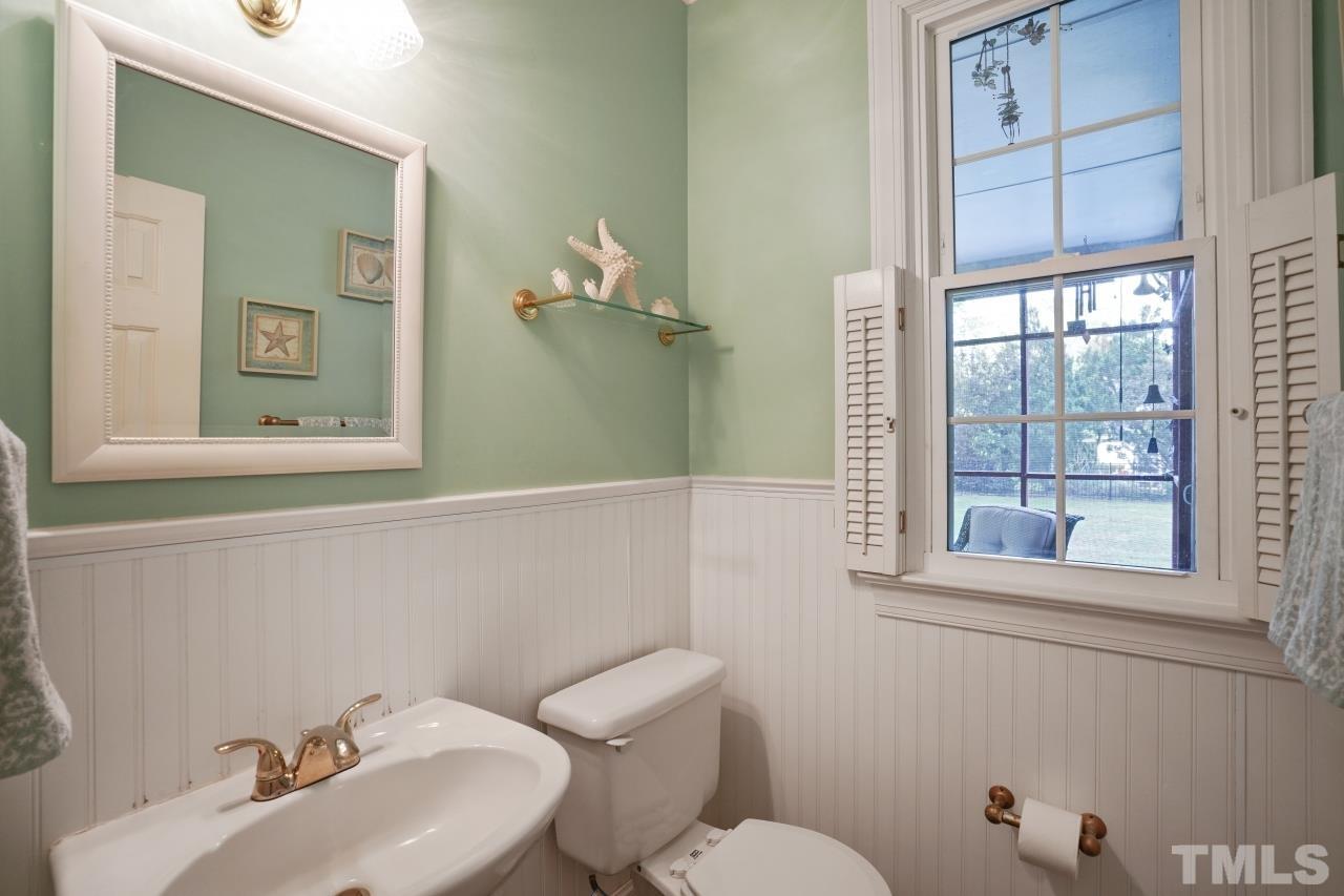 1505 Habbot Drive Raleigh, NC 27603 - Photo 13 of 32 a bathroom with a toilet sink and mirror