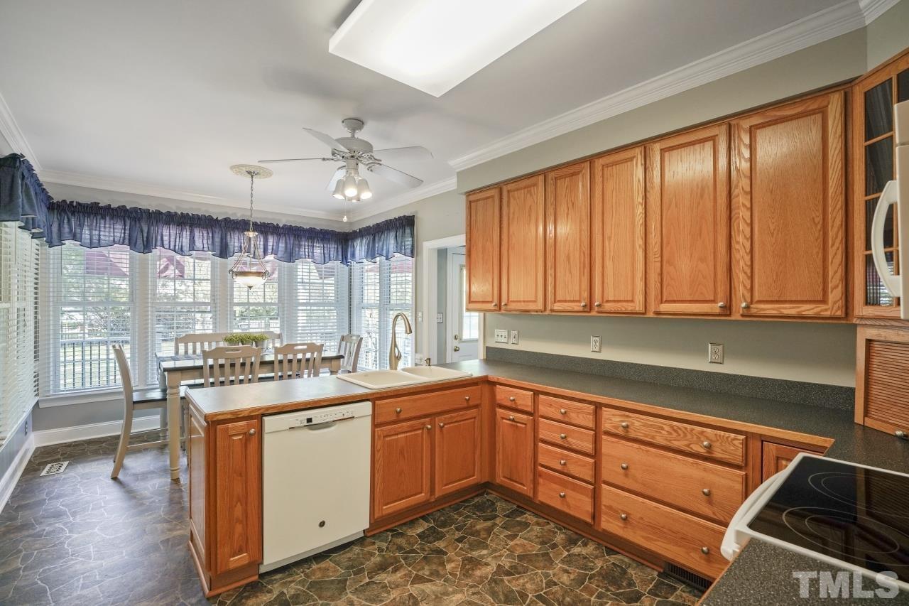 1505 Habbot Drive Raleigh, NC 27603 - Photo 15 of 32 a kitchen with a sink window and cabinets