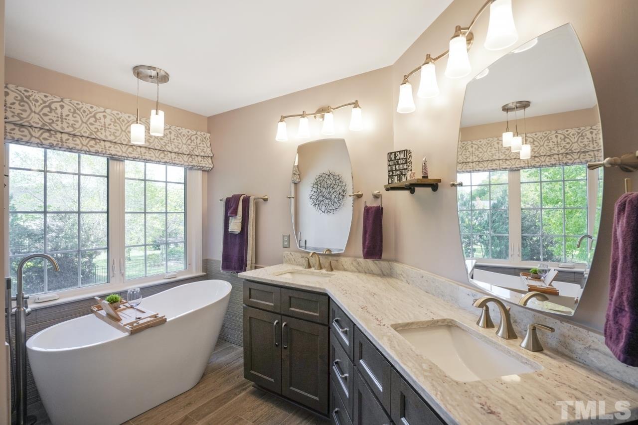 1505 Habbot Drive Raleigh, NC 27603 - Photo 18 of 32 a bathroom with a granite countertop sink and a large mirror